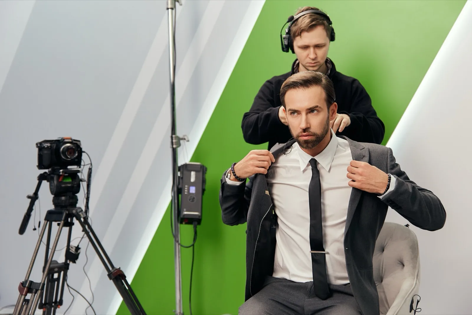 A minute before airtime: the host is being mic’d up